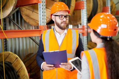 SHE Technician UK apprentices carrying out tasks in the workplace wearing PPE