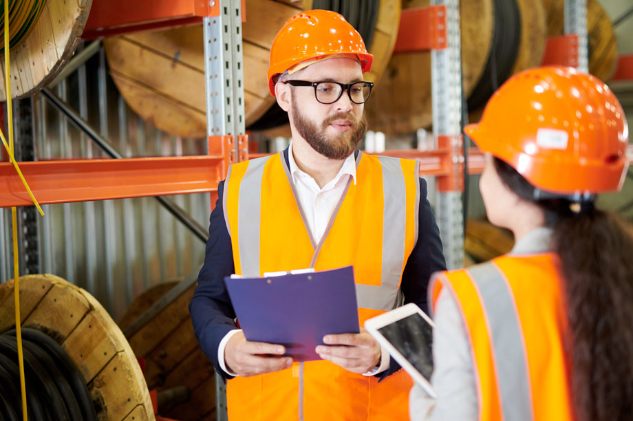 SHE Technician UK apprentices carrying out tasks in the workplace wearing PPE